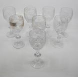 A set of eight cut crystal wine glasses, etched with fruiting vines