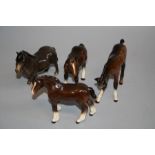 A Beswick Shetland pony, number 1648, brown gloss glazed, a foal, number 947 and two other foals,