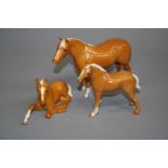 A Beswick palomino foal, a palomino lying foal and one other palomino horse (3) Chip to ear of
