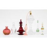 A collection of glass perfume bottles, including early 20th Century ruby glass bottle with stopper