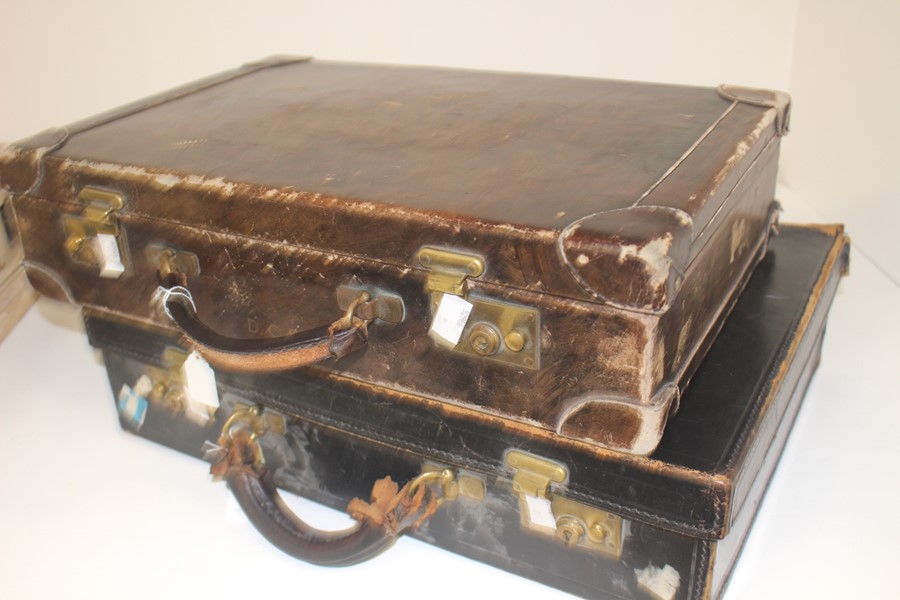 Two early 20th Century leather suitcases, one with impressed initials. (2)