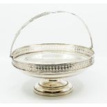 A George V silver large circular fruit basket, swing handle the body with reticulated upper