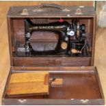 A cased Singer sewing machine, the case is faux crocodile skin