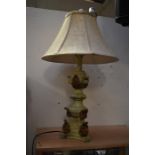 A French Empire style table lamp, in craquelure effect, having a cream shade, with a turned