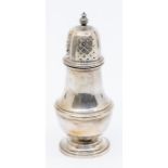 A Georgian style silver caster, plain body, the cover with pierced decoration, urn shaped finial, by