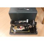 A mid 20th Century cased sewing machine