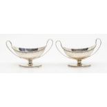 A pair of George III silver twin handled boat shaped condiments, beaded borders and bright cut