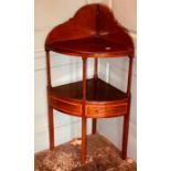 A George III mahogany corner washstand, circa 1790, raised back, undertier with a single crossbanded