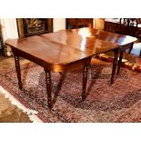 A George III mahogany dining table, circa 1790-1800, curved ends, additional leaf, baluster and ring