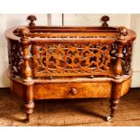 A Victorian figured walnut bow form Canterbury, circa 1860, acanthus carved finials on baluster