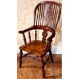 A 19th century yew and elm hoop back Windsor farmhouse elbow chair, the central pierced splat