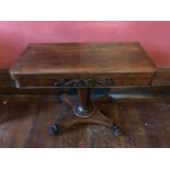 A Regency rosewood games table, circa 1820, fold-over top with inset green gauze, tapered support,