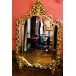 A gilt wood console table and pier glass of Rococo design, 20th Century, serpentine marble top (s.