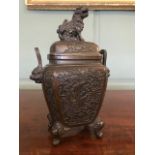 A 19th Century Chinese bronze censer, the domed cover with a Foo dog finial, the vessel with beast