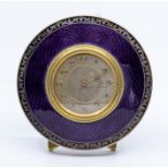 A George V silver circular easel desk or bedside timepiece, purple guilloche enamel frame in a black