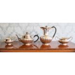A George V four piece silver tea set, circular stop-fluted shapes with foliate borders maker