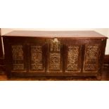 A William III and later oak coffer, rectangular hinge lid, claw lock above a five carved panels on