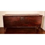A James I oak plank chest, circa 1620, plank top with a moulded edge, blacksmith hinges, I..T