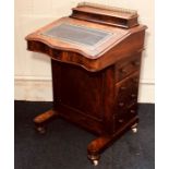 A Victorian burr walnut davenport, circa 1860, three quarter brass gallery on a moulded hinged lid