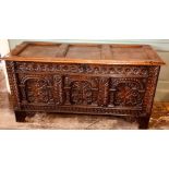 A Charles II oak chest, circa 1640-1680, triple panelled top with wire hinges, arcaded front