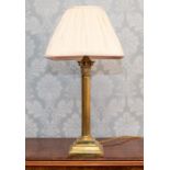 A Victorian brass corinthian column table lamp on stepped plinth, with a pleated fabric shade, (