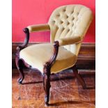 A mid Victorian mahogany framed reading chair, circa 1860, button back green velvet upholstery,