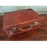 An Edwardian crocodile skin dressing case by Boswell, Edinburgh, brass fittings, gilt monogram A.M.