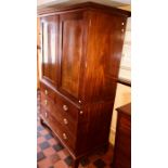 A George IV mahogany linen press, circa 1820, out swept moulded cornice enclosed by moulded panel