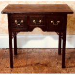 A George III oak low boy, the rectangular moulded top above an arrangement of one long and two small