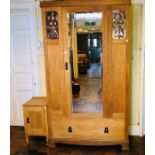 An Arts & Crafts light oak single wardrobe, circa 1905, central door with a mirror flanked by panels