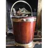 A George III mahogany and brass bound peat bucket, circa 1800, of coopered construction with brass