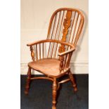 An early 19th century elm and beech high hoop back Windsor armchair, in Yorkshire region manner,