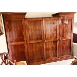 A Victorian mahogany inverted breakfront compactum wardrobe, circa 1860, twin out swept cornice on