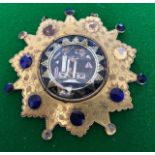 A George III gilt metal Masonic badge, the mount of sunburst form bright cut engraved foliage