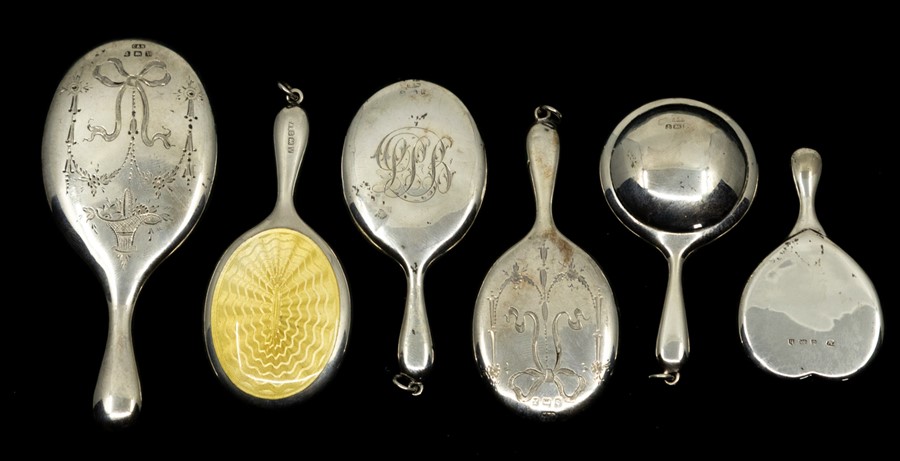 A collection of six miniature or toy silver hand mirrors, three with bright cut engraved backs,