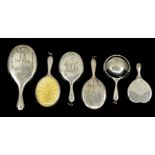 A collection of six miniature or toy silver hand mirrors, three with bright cut engraved backs,