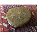 A Victorian mahogany framed circular footstool, circa 1860, upholstered cushion with beadwork