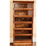 A Globe Wernicke oak six tier stacked bookcase, labels to the interiors of "Globe Wernicke Co LTD,