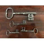 A collection of four antique steel door keys, of various sizes including one large example, height