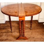 A late Victorian burr walnut Sutherland table, circa 1890, oval drop ends, ring turned legs and