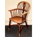 A 19th Century elm and ash low hoop back Windsor armchair, shaped and pierced splat flanked by
