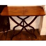 A  mid 19th Century mahogany campaign coaching table, folding top with an X framed base with