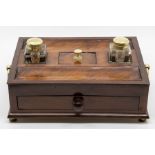 A 19th Century mahogany desk inkstandish, twin clear glass cube inks, two pen wells, single frieze