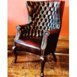 A George III revival barrel back library chair, 20th Century, studded and button back ox blood