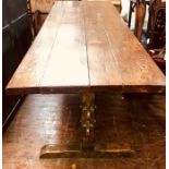 An 18th Century elm and oak farmhouse 12 seater dining table, solid four plank elm top, raised on