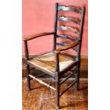 An Arts & Crafts ladder back armchair, circa 1920, scroll arms, rush seat, ring turned legs,