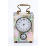 A late 19th Century miniature mother of pearl carriage alarm clock, swing handle, enamel dial and