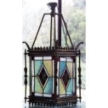 A late Victorian brass hall pendant lantern, circa 1880, of square section with four leaded