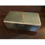 A George V silver table cigarette casket, machine engraved Art Deco design to the cover, maker