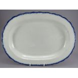 An early nineteenth century pearlware shell-edge platter, c. 1820. It has a blue-painted edge and is